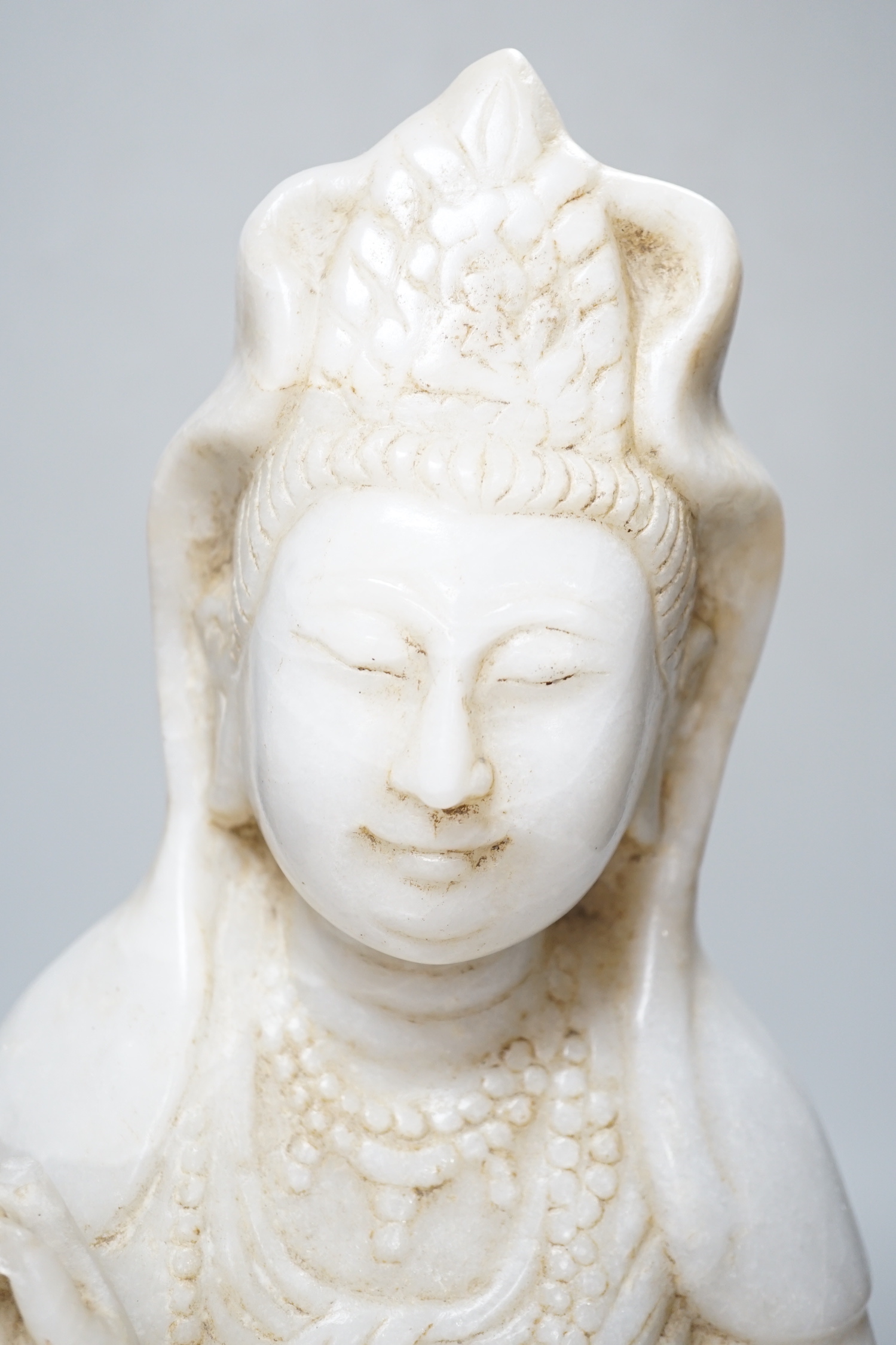 A Chinese carved marble figure of Guanyin, 42cm high